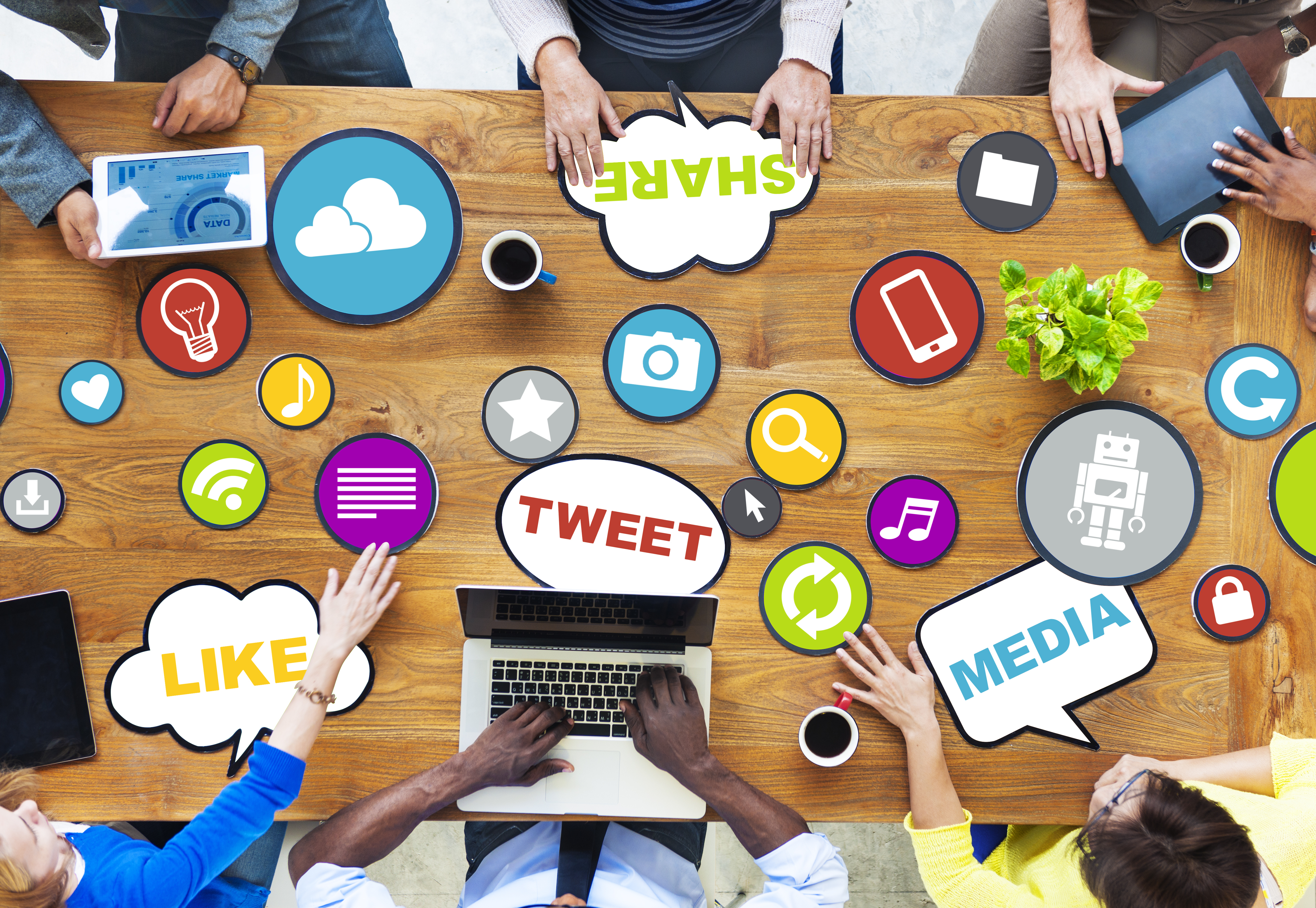 a group of people on a table with colorful pages they are all on social media